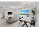 Cozy living space features modern lighting, an open floor plan, and a scenic view of the water for relaxation at 1020 Sunset Point Rd # 410, Clearwater, FL 33756