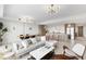 Bright, open-concept living area connecting to a modern kitchen with sleek appliances and a comfortable seating arrangement at 1020 Sunset Point Rd # 410, Clearwater, FL 33756