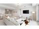 Inviting living area features a stylish decor, a modern ceiling fan, and easy access to the kitchen and dining spaces at 1020 Sunset Point Rd # 410, Clearwater, FL 33756