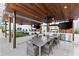 Great outdoor kitchen with stainless steel appliances, bar, and dining at 1020 Sunset Point Rd # 410, Clearwater, FL 33756
