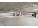 Bright parking garage with painted ceilings, support columns, and multiple parking spots at 1020 Sunset Point Rd # 410, Clearwater, FL 33756