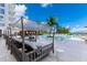 Upscale pool area with daybeds, umbrellas, and ocean views; relax in style at 1020 Sunset Point Rd # 410, Clearwater, FL 33756