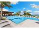 Inviting pool area with palm trees and lounge chairs for relaxation at 1020 Sunset Point Rd # 410, Clearwater, FL 33756