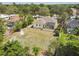Aerial view showcases the home, yard, mature trees and the screened-in lanai at 10306 Shalimar Wood Dr, Thonotosassa, FL 33592