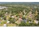 An elevated aerial view, nestled amongst trees, showcasing surrounding houses and wooded areas at 10306 Shalimar Wood Dr, Thonotosassa, FL 33592