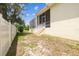 View of the home's backyard with a screened-in lanai, and a white fence at 10306 Shalimar Wood Dr, Thonotosassa, FL 33592