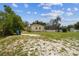 View of the spacious backyard showcasing landscaping, fencing and a lanai at 10306 Shalimar Wood Dr, Thonotosassa, FL 33592