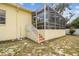 Home's backyard features a screened-in lanai with stairs and a patio at 10306 Shalimar Wood Dr, Thonotosassa, FL 33592