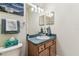 Bathroom with a toilet, blue countertop, and wood-look cabinets at 10306 Shalimar Wood Dr, Thonotosassa, FL 33592