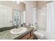 Bathroom with a tub and shower, vanity with granite countertops, and a well-lit mirror at 10306 Shalimar Wood Dr, Thonotosassa, FL 33592
