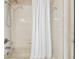 Clean white tub and tile shower with a white shower curtain at 10306 Shalimar Wood Dr, Thonotosassa, FL 33592