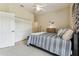 Bedroom with neutral tones featuring a comfortable bed, a large closet, and natural light at 10306 Shalimar Wood Dr, Thonotosassa, FL 33592