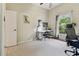 Bedroom featuring neutral walls, carpet, and an office setup by the window at 10306 Shalimar Wood Dr, Thonotosassa, FL 33592
