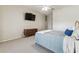 Comfortable bedroom with a mounted TV and soft carpet flooring at 10306 Shalimar Wood Dr, Thonotosassa, FL 33592