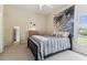 Bedroom featuring soft neutral tones, a comfortable bed, a large window and natural light at 10306 Shalimar Wood Dr, Thonotosassa, FL 33592
