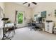 Bright bedroom featuring neutral walls, carpet, and an office setup at 10306 Shalimar Wood Dr, Thonotosassa, FL 33592