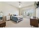 Inviting bedroom with plush carpet and a large window at 10306 Shalimar Wood Dr, Thonotosassa, FL 33592