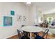 Cozy dining area features hardwood floors, cheerful decor, and ample natural light at 10306 Shalimar Wood Dr, Thonotosassa, FL 33592