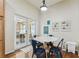 Bright dining area with doors to an outside patio, hardwood floors, and table with chairs at 10306 Shalimar Wood Dr, Thonotosassa, FL 33592