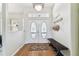 Bright and airy foyer with hardwood floors, decorative front doors, and stylish accents at 10306 Shalimar Wood Dr, Thonotosassa, FL 33592