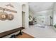 Foyer with a coat rack and bench, opens into a living room with French doors at 10306 Shalimar Wood Dr, Thonotosassa, FL 33592