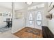 Light-filled foyer featuring a double front door, wood floors, and a bench at 10306 Shalimar Wood Dr, Thonotosassa, FL 33592