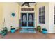 A welcoming front entry with decorative double doors, stylish decor, and a sunny atmosphere at 10306 Shalimar Wood Dr, Thonotosassa, FL 33592