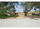 Charming single-story home with a three-car garage, landscaped yard, and long brick driveway at 10306 Shalimar Wood Dr, Thonotosassa, FL 33592