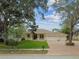 Charming single-story home with a three-car garage, landscaped yard, and inviting front porch at 10306 Shalimar Wood Dr, Thonotosassa, FL 33592