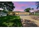 Charming single-story home with a three-car garage, landscaped yard, and inviting front porch at 10306 Shalimar Wood Dr, Thonotosassa, FL 33592