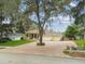 Charming single-story home with a three-car garage, landscaped yard, and long brick driveway at 10306 Shalimar Wood Dr, Thonotosassa, FL 33592