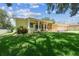 Charming single-story home with a two-car garage, landscaped yard, and inviting front porch at 10306 Shalimar Wood Dr, Thonotosassa, FL 33592