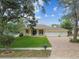 Charming single-Gathering home with a well-manicured lawn, brick driveway, and an attached garage at 10306 Shalimar Wood Dr, Thonotosassa, FL 33592