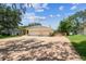 Charming single-story home with a three-car garage, landscaped yard, and long brick driveway at 10306 Shalimar Wood Dr, Thonotosassa, FL 33592