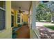 Charming front porch featuring decorative columns, comfortable seating, and a welcoming entrance at 10306 Shalimar Wood Dr, Thonotosassa, FL 33592