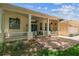 Inviting front porch with brick pavers, decorative columns, and ample seating area at 10306 Shalimar Wood Dr, Thonotosassa, FL 33592