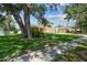 Well maintained single story home with lush lawn, mature landscaping and covered entrance at 10306 Shalimar Wood Dr, Thonotosassa, FL 33592