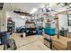 View of a spacious garage with storage racks, a car, and moving supplies at 10306 Shalimar Wood Dr, Thonotosassa, FL 33592