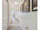 Hallway with carpet, white walls, and decorated with framed posters at 10306 Shalimar Wood Dr, Thonotosassa, FL 33592