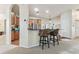 Open concept kitchen with bar seating, wood cabinets, and stainless steel appliances at 10306 Shalimar Wood Dr, Thonotosassa, FL 33592