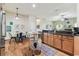 Open kitchen featuring wood cabinets, stainless steel appliances, and a dining area nearby at 10306 Shalimar Wood Dr, Thonotosassa, FL 33592