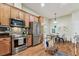 Spacious kitchen with stainless steel appliances, wooden cabinets, and a cozy breakfast nook at 10306 Shalimar Wood Dr, Thonotosassa, FL 33592