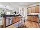 Bright kitchen featuring wood cabinets, stainless steel appliances, and granite countertops at 10306 Shalimar Wood Dr, Thonotosassa, FL 33592