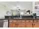 Kitchen sink and counter detail featuring dark countertops and wood cabinets overlooking the living area at 10306 Shalimar Wood Dr, Thonotosassa, FL 33592