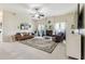 Spacious living room features a fireplace, ceiling fan, and comfortable leather sofa at 10306 Shalimar Wood Dr, Thonotosassa, FL 33592