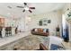 Open living room showcasing a cozy sofa, ceiling fan, and seamless flow to the dining area at 10306 Shalimar Wood Dr, Thonotosassa, FL 33592