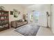Cozy living room featuring a sofa, bookcase, and French doors to the outside at 10306 Shalimar Wood Dr, Thonotosassa, FL 33592