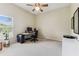A bright room with a large window features a desk and office setup, ideal for remote work or study at 10306 Shalimar Wood Dr, Thonotosassa, FL 33592
