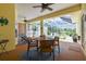 Covered patio with a dining table and seating area, providing a relaxing outdoor space for entertaining or dining at 10306 Shalimar Wood Dr, Thonotosassa, FL 33592