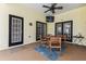 Covered patio with a dining table and seating area with view into screened in pool area, ideal for entertaining or dining at 10306 Shalimar Wood Dr, Thonotosassa, FL 33592